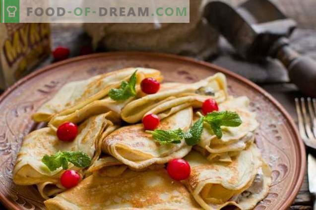 French crepes. Thin pancakes with prunes and curd